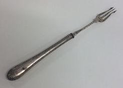 An Edwardian silver pickle fork with beaded rim. E