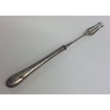 An Edwardian silver pickle fork with beaded rim. E