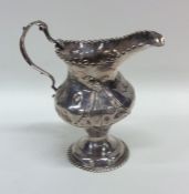 A Georgian silver cream jug with ball rim to gadro