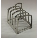 A heavy Edwardian silver toast rack on bracket fee