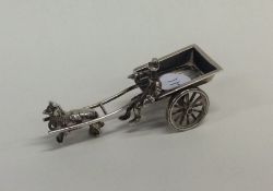 A small silver table toy in the form of a horse an