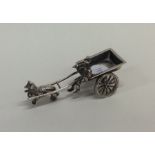 A small silver table toy in the form of a horse an