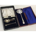 A boxed child's silver pusher and spoon together w