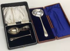 A boxed child's silver pusher and spoon together w