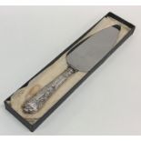 A cased Kings' pattern silver cake knife with stee