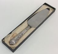 A cased Kings' pattern silver cake knife with stee