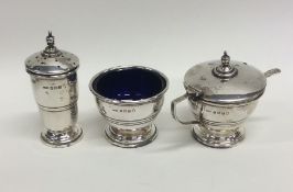 An Edwardian silver three piece silver cruet set.