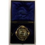 A large gold mourning brooch with locket back and