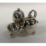 An unusual silver cruet with glass liners and ball