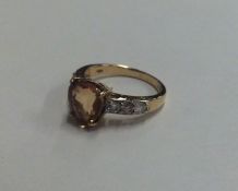 An 18 carat gold diamond and yellow sapphire ring