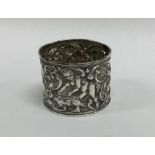A silver napkin ring decorated with cherubs and an