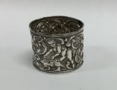 A silver napkin ring decorated with cherubs and an