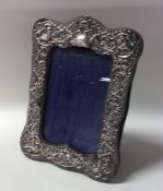 A silver embossed picture frame with velvet back.