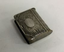 A silver plated vesta case in the form of a book.