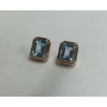 A pair of stylish blue topaz ear pendants in 18 ca