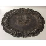 A large oval silver serving dish mounted with flow