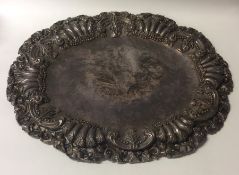 A large oval silver serving dish mounted with flow