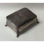 A silver sloping top jewellery box with engine tur