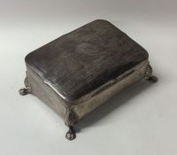 A silver sloping top jewellery box with engine tur
