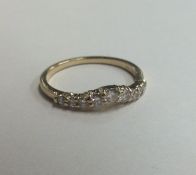 An unusual 14 carat gold and diamond wishbone ring