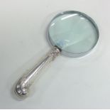 An unusual silver handled magnifying glass of scro