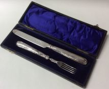 A cased silver two piece christening set with tape