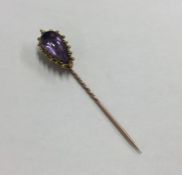 A high carat gold single stone amethyst stick pin.