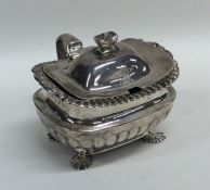 A Georgian half fluted silver mustard pot on claw