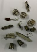 A box containing silver brooches, thimbles etc. Ap
