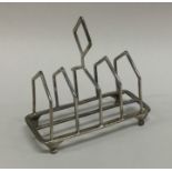 An Art Deco silver toast rack on tapering supports