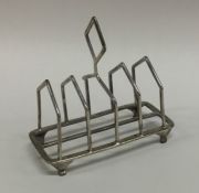 An Art Deco silver toast rack on tapering supports