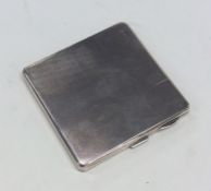 An engine turned square cigarette case with vacant