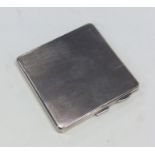 An engine turned square cigarette case with vacant