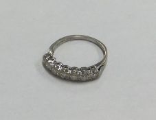 A seven stone diamond ring in claw mount in 18 car
