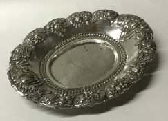 An oval Indian embossed silver dish decorated with
