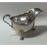 An Edwardian silver sauce boat with beaded rim on