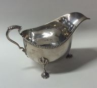 An Edwardian silver sauce boat with beaded rim on