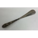 A silver embossed shoe horn. Approx. 72 grams. Est