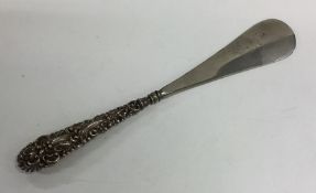 A silver embossed shoe horn. Approx. 72 grams. Est