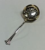 A silver sifter spoon with gilt bowl. London. Appr