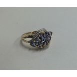A diamond and tanzanite cluster ring in 9 carat mo