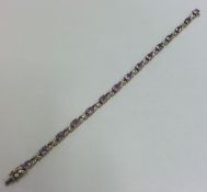 An amethyst and diamond line bracelet with conceal