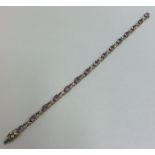 An amethyst and diamond line bracelet with conceal