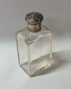 An Edwardian silver mounted dressing table bottle