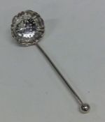 A small silver sifter spoon with pierced bowl. She