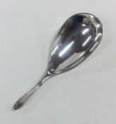 An unusual silver caddy scoop with reeded handle.