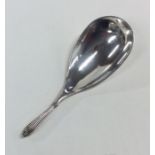 An unusual silver caddy scoop with reeded handle.