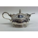 An Edwardian silver mustard pot with hinged lid to