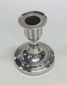 A Georgian silver single candlestick on circular b