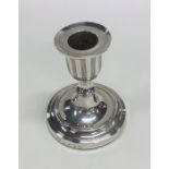 A Georgian silver single candlestick on circular b